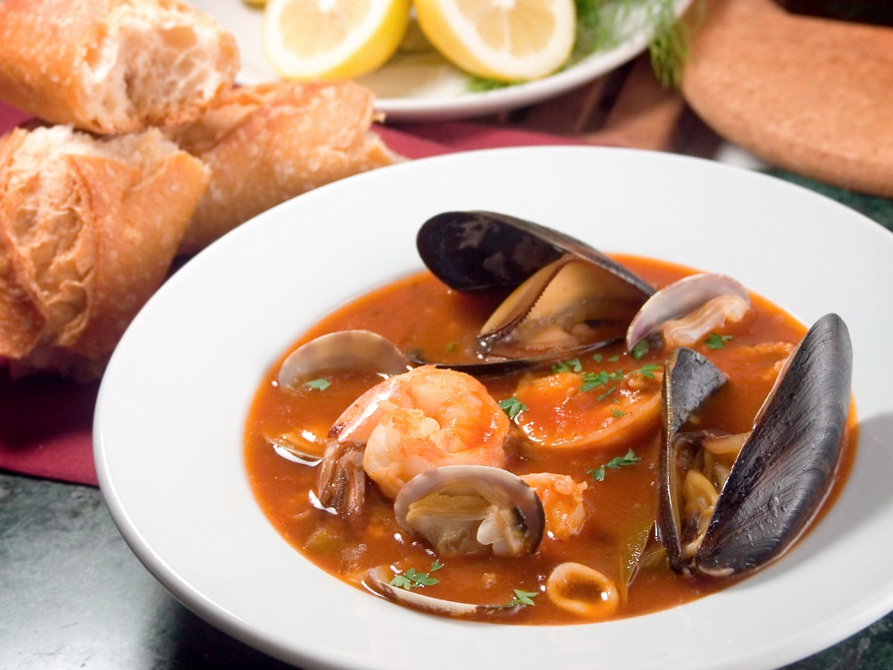 Robust stew, similar to a bouillabaisse features a variety of the sea's edible treasures such as baby manila clams mussels prawns calamari　sea bass and crab in a rich tomato base　©Kcline